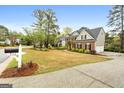 Wide view of home with 3 car garage, driveway and luscious landscaping at 216 Southwick Ln, Peachtree City, GA 30269