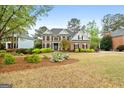 Beautiful brick two-story home with well-manicured lawn and decorative plants at 216 Southwick Ln, Peachtree City, GA 30269