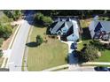 Expansive lawn with meticulously maintained landscaping and a lengthy driveway on corner lot at 200 Kensington Trce, Stockbridge, GA 30281