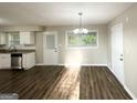 Eat-in kitchen boasts stainless appliances, granite countertops, and a dining area with a modern chandelier and lots of natural light at 2099 Yucca Dr, Decatur, GA 30032