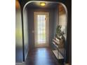 Welcoming entryway with dark hardwood floors, archway and decorative wood paneling at 3168 Spicy Cedar Ln, Lithonia, GA 30038