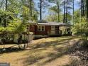 View of the backyard featuring a brick house with a wooden deck and partially fenced yard at 1815 Dodson Sw Dr, Atlanta, GA 30311