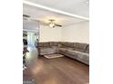 Bright living room featuring hardwood floors and a large sectional for comfortable seating at 11755 Highway 36, Covington, GA 30014
