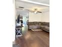 Spacious living room featuring hardwood floors, a ceiling fan, and a large sectional sofa at 11755 Highway 36, Covington, GA 30014