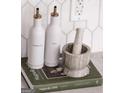 Stylish kitchen details with oil and vinegar bottles displayed on 'Magnolia Table' cookbook at 185 Wadley Nw St, Atlanta, GA 30314