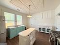 Eat-in kitchen with an island, stainless steel appliances, vintage ceiling and a classic color scheme at 30 Poplar St, Porterdale, GA 30014