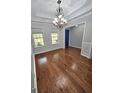 Hardwood flooring, decorative molding, and bright natural light in this dining area with a modern chandelier at 64 Shadow Ct, Palmetto, GA 30268