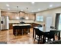 Spacious open-concept kitchen and dining area with hardwood floors and plenty of seating at 9108 Alden Dr, Locust Grove, GA 30248