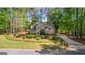 Beautiful two-story home with a red door, surrounded by lush greenery and mature trees at 226 Le Paradis Blvd, Sharpsburg, GA 30277