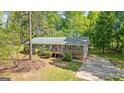 Inviting single-story house with a cozy porch, a well-maintained yard, and a convenient driveway at 1256 Horsley Mill Rd, Carrollton, GA 30116