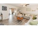Inviting living room with hardwood floors, a ceiling fan, and a comfortable sectional sofa at 15 Pine Run Rd, Carrollton, GA 30116