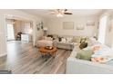 Comfortable living room with a large sectional sofa, ceiling fan, and hardwood floors at 15 Pine Run Rd, Carrollton, GA 30116