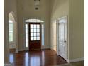 Bright foyer with dark wood flooring and a windowed front door at 30 Scouts Ridge Dr, Covington, GA 30016