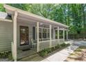 Inviting front porch with white picket fence and seating area, perfect for enjoying the outdoors at 146 Highland Cir, Mcdonough, GA 30253