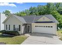 Charming single-Gathering home featuring manicured lawn, attached garage, and a welcoming facade at 462 Chase Marion Way, Mcdonough, GA 30253