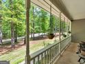 The home features a long covered porch with hanging plants and a serene view at 50 Ridgeview Dr, Jonesboro, GA 30236