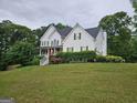 Traditional white home with lush greenery providing a serene and private setting at 22 Shea Ct, Douglasville, GA 30134