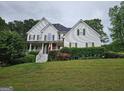 Inviting home featuring a classic design with a well-maintained lawn and mature landscaping at 22 Shea Ct, Douglasville, GA 30134
