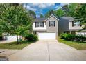 Charming two-story home boasts a combination of light beige siding and gray brick, and a two-car garage at 11224 Aliyah Dr, Hampton, GA 30228