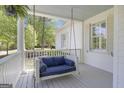 Relaxing porch featuring a comfortable swing and a view of the surrounding landscape at 105 Suffolk Pl, Fayetteville, GA 30215