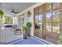Cozy front porch with comfortable seating, ceiling fan and an inviting entryway at 105 Suffolk Pl, Fayetteville, GA 30215