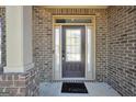 Close-up of a stylish front door with glass panel and sidelights at 9929 Musket Ridge Cir, Jonesboro, GA 30238