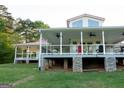 Expansive back porch with ceiling fans, ideal for outdoor living, features red roof at 4076 Airline Rd, Mcdonough, GA 30252