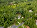 Beautiful property nestled among mature trees on a spacious lot with well manicured landscaping at 135 Adams Park Dr, Fayetteville, GA 30214