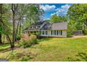 Charming two-story home with beautiful landscaping and a well-maintained lawn at 3341 Deer Hollow Sw Trl, Conyers, GA 30094