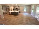 Modern kitchen with gray cabinets, stainless steel appliances, a center island, and lots of natural light at 165 Jodi Pl, Locust Grove, GA 30248