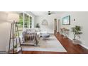 Bright living room featuring a large window, modern ceiling fan, and comfortable seating area with stylish decor at 1120 Starline Dr, Smyrna, GA 30080