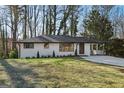 Charming single-story home with a white brick exterior and a well-manicured front yard at 1120 Starline Dr, Smyrna, GA 30080