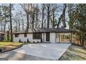Charming single-story home with a white brick exterior and a well-manicured front yard at 1120 Starline Dr, Smyrna, GA 30080