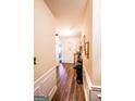 Bright hallway with wood floors, decorative wainscoting, and elegant decor at 386 Hill Crest Cir, Hiram, GA 30141