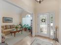 Inviting foyer with hardwood floors, a decorative front door, and a view into a cozy living room at 925 Champions Way, Mcdonough, GA 30252