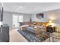 Inviting living room featuring a plush sectional sofa, stylish coffee table, and sliding glass doors at 93 Rue Fontaine, Lithonia, GA 30038