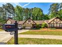 Front of house featuring Tudor accents, mailbox and green grass at 335 Jeff Davis Pl, Fayetteville, GA 30214