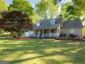 Charming home with a welcoming front porch, complemented by a beautifully landscaped lawn at 201 Little New York Rd, Carrollton, GA 30116