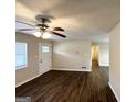 Bright living room featuring new vinyl flooring, a ceiling fan, and a large window at 2361 Collier Dr, Decatur, GA 30032