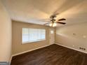 Inviting living room with modern vinyl floors, large window, and white trim at 2361 Collier Dr, Decatur, GA 30032