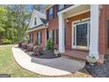 Close-up of front entrance showing well-maintained landscaping and a welcoming porch at 65 Jacksons Vly, Sharpsburg, GA 30277