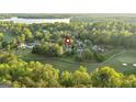 Scenic aerial perspective of a home nestled near a golf course and picturesque lake at 110 Cadmium Ct, Peachtree City, GA 30269