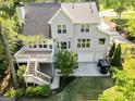 Aerial view of a home showcasing its deck, two-car garage, and lush surroundings at 110 Cadmium Ct, Peachtree City, GA 30269