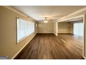 Bright living space featuring hardwood floors, neutral paint, a ceiling fan, and a glimpse into the dining area at 668 Fielding Sw Ln, Atlanta, GA 30311