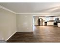 Bright and spacious living room showcasing modern hardwood floors, neutral paint, and a seamless flow into the kitchen at 668 Fielding Sw Ln, Atlanta, GA 30311