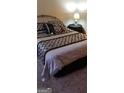 Bedroom with a comfortable bed covered with black and white patterned comforter at 472 Harvick Cir, Stockbridge, GA 30281