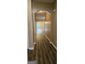 Hallway features arched entryway, wood-look flooring, and neutral wall color at 2867 Snapfinger Mnr, Decatur, GA 30035