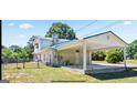 Rear exterior view of a two-story home with a carport and fenced yard at 732 Sandhill Shady Grove Rd, Carrollton, GA 30116