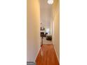 Hallway view leading to living room with fireplace, furniture, and staircase at 25 Pacific Ave, Sharpsburg, GA 30277