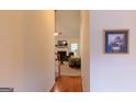 Hallway view leading to a bright living room with a fireplace and neutral colored furniture at 25 Pacific Ave, Sharpsburg, GA 30277